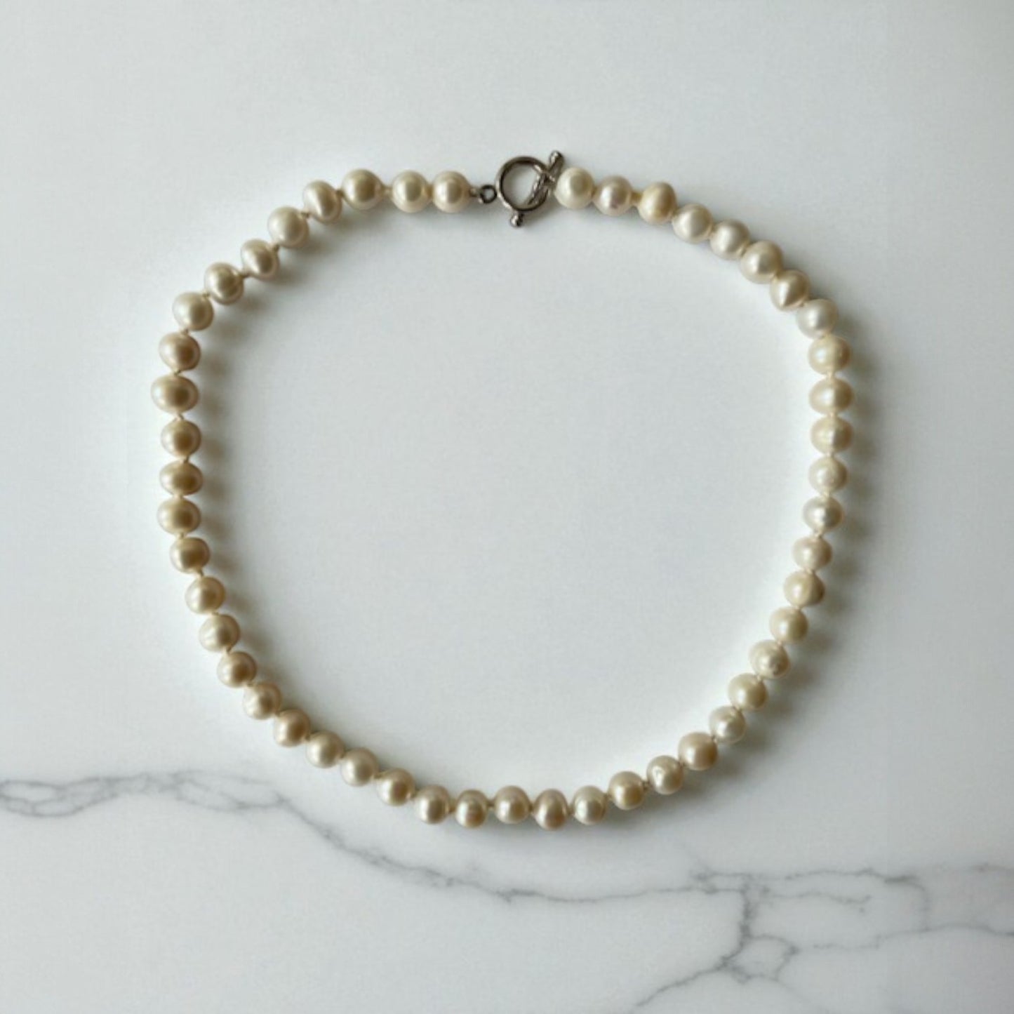 freshwater pearl necklace with sterling silver clasp, hand knotted with 100% silk thread.