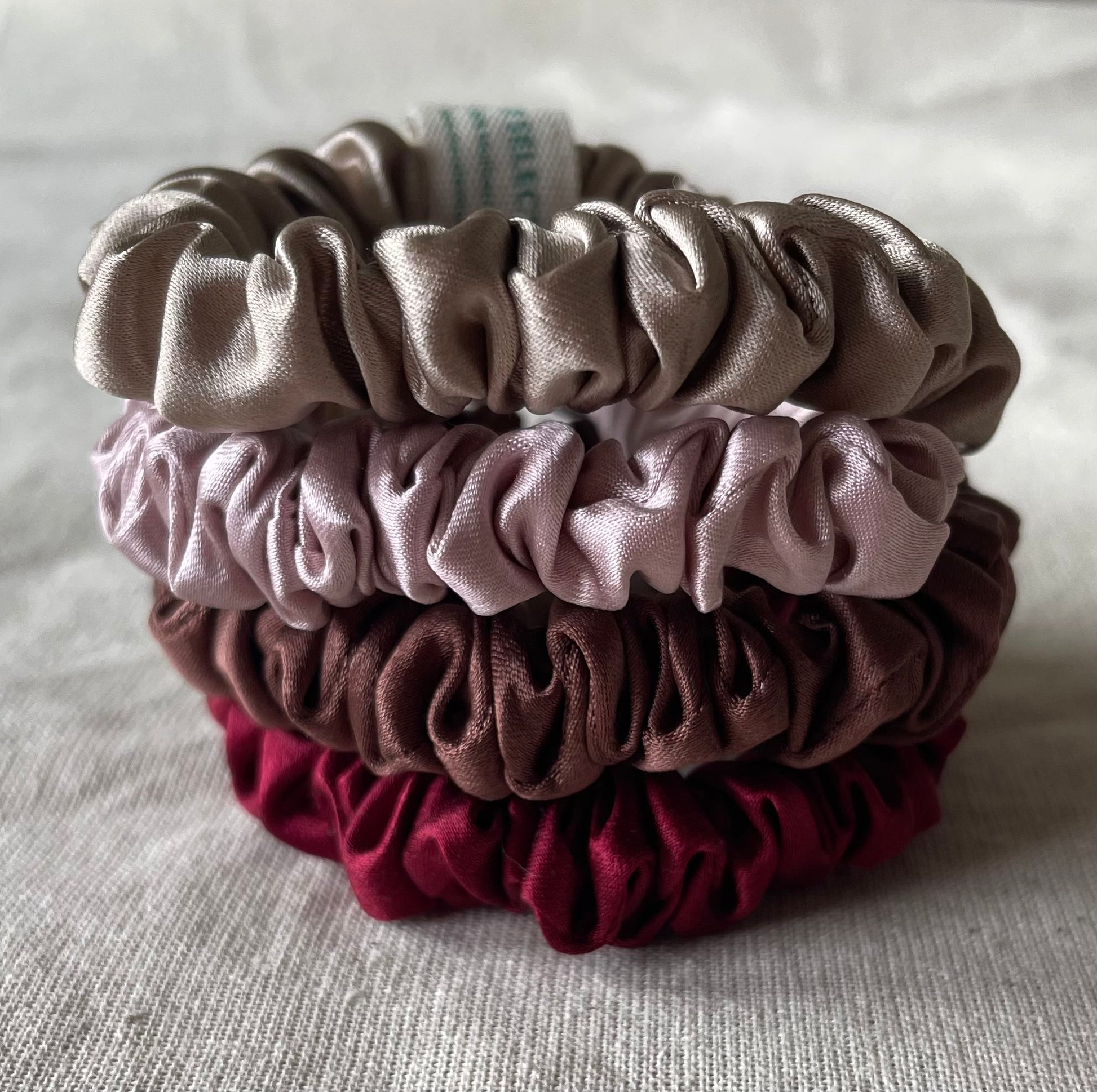 Four 100% 30 momme silk scrunchies in 1 cm wide with dusty pink,Bordeaux,chocolate brown,nude colors