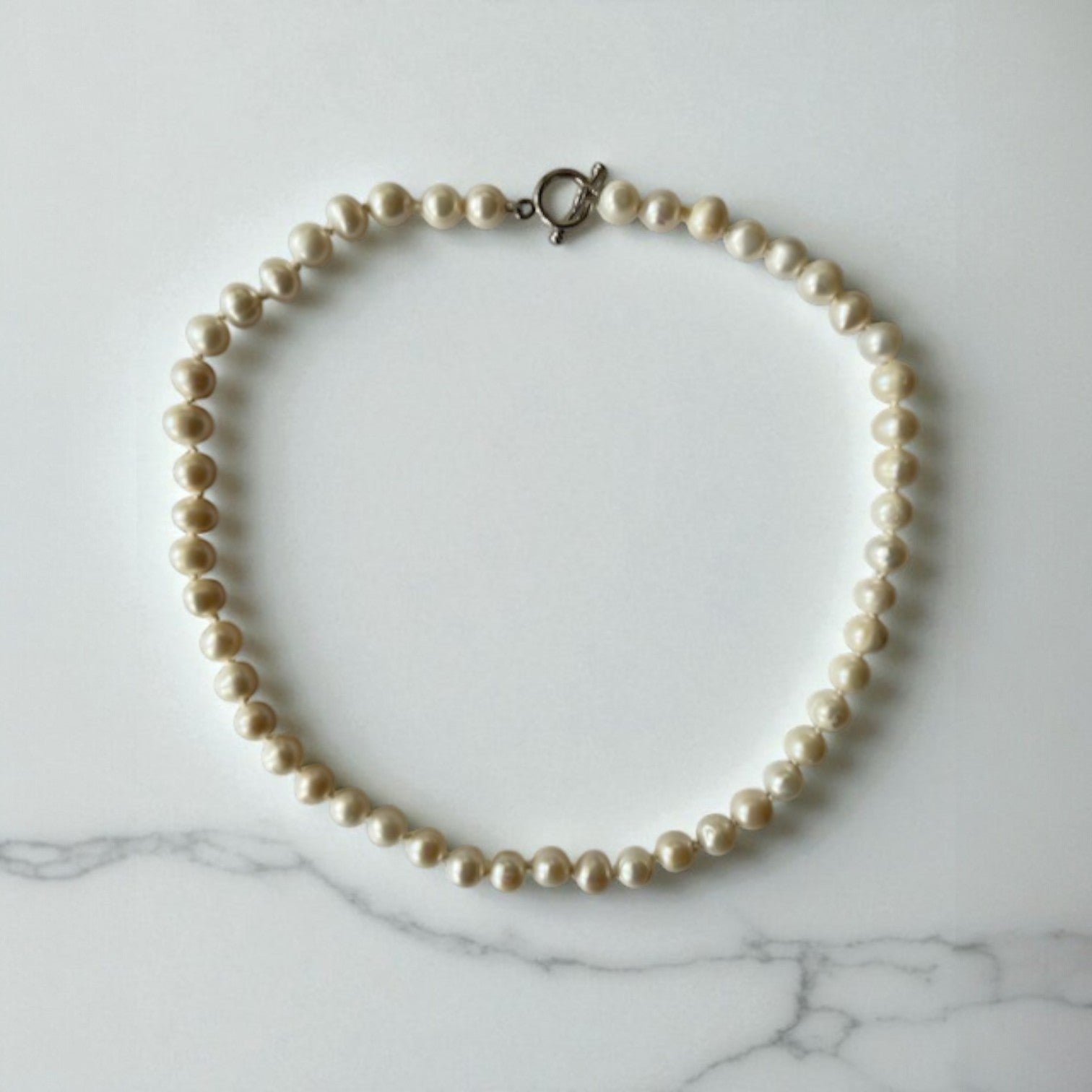 freshwater pearl necklace with sterling silver clasp, hand knotted with 100% silk thread.