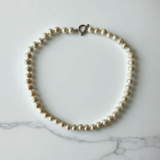 freshwater pearl necklace with sterling silver clasp, hand knotted with 100% silk thread.