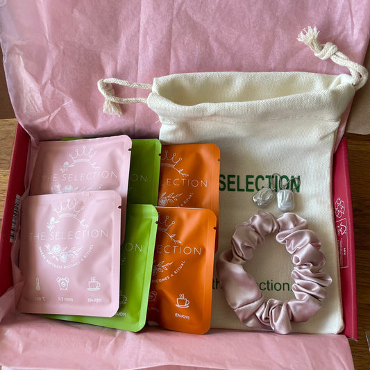 Gift box with 6 bags of herbal loose leaf teas with 100% corn fiber tea bags: 1 30 momme thick silk scrunchie, one paire of baroque square freshwater pearl earrings with 925 sterling silver hooks, 1 pure cotton pouch 