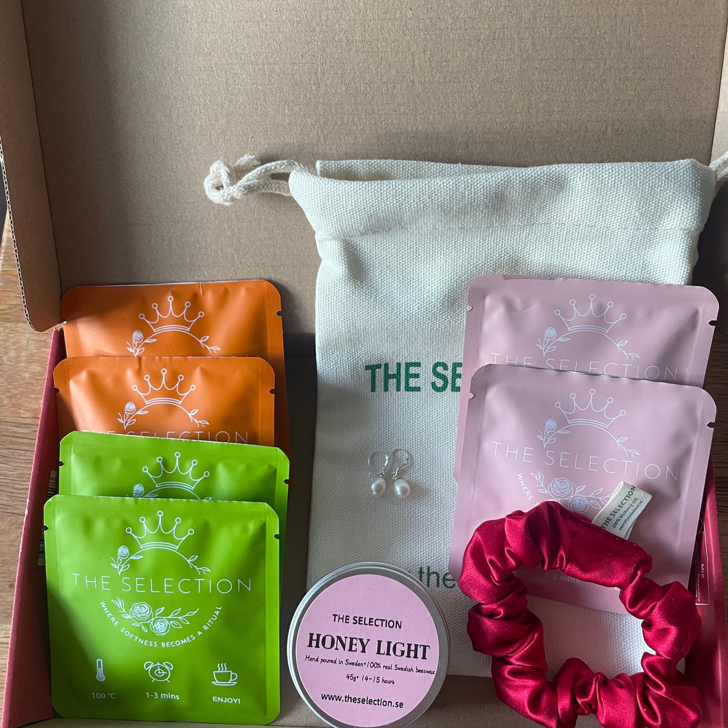 Gift box with 6 herbal loose leaf tea, 1 pure Swedish rapeseed scented candle,1 30 momme silk scrunchie And 1 pair of freshwater pearl earrings with 925 sterling silver hooks 